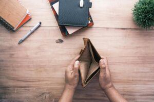 Holding an empty wallet.