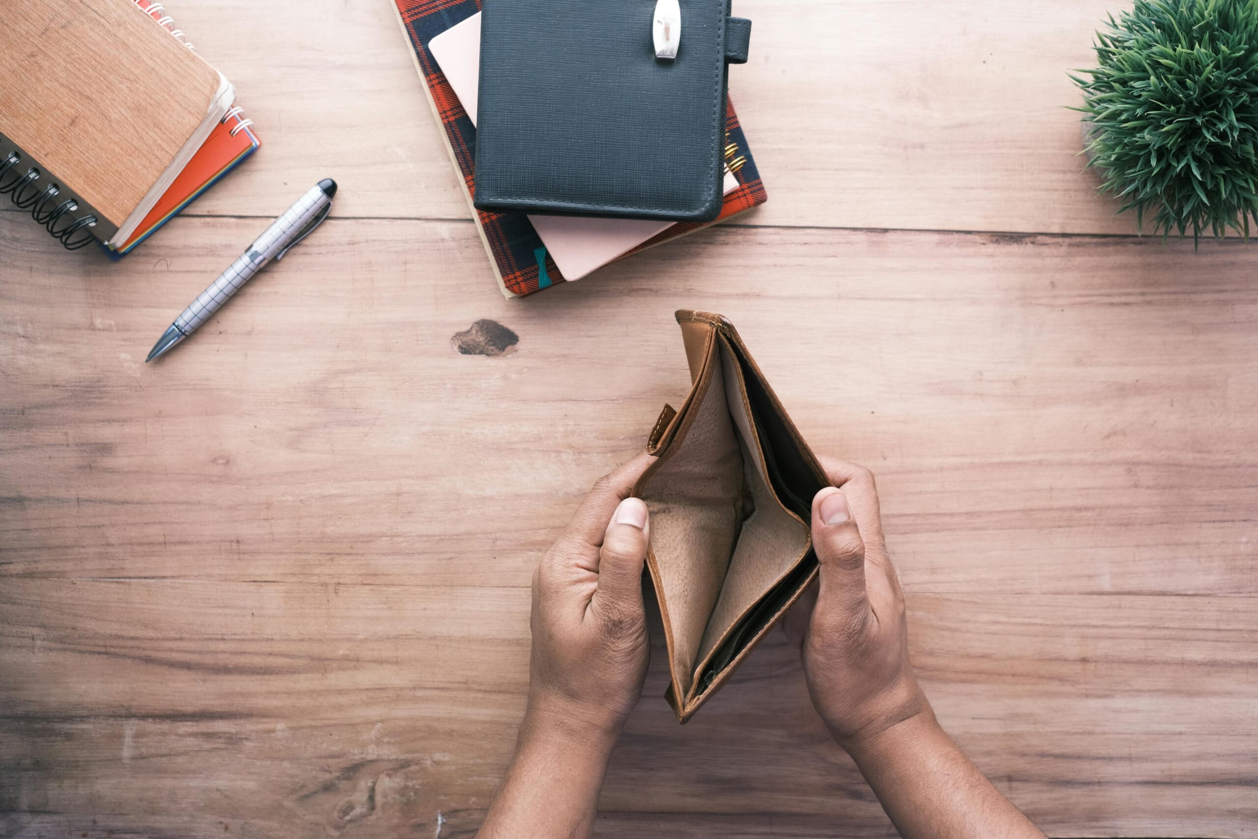 Holding an empty wallet.